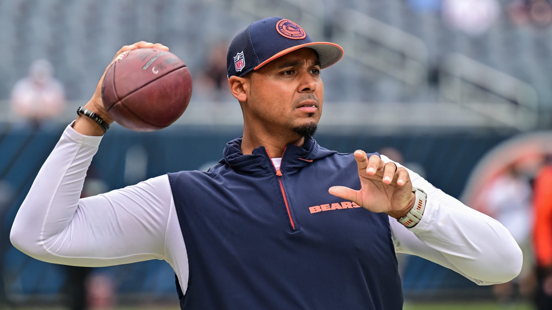 Aug 17, 2024; Chicago, Illinois, USA; Chicago Bears general manager Ryan Poles plays catch on the sideline before the game against the Cincinnati Bengals at Soldier Field.